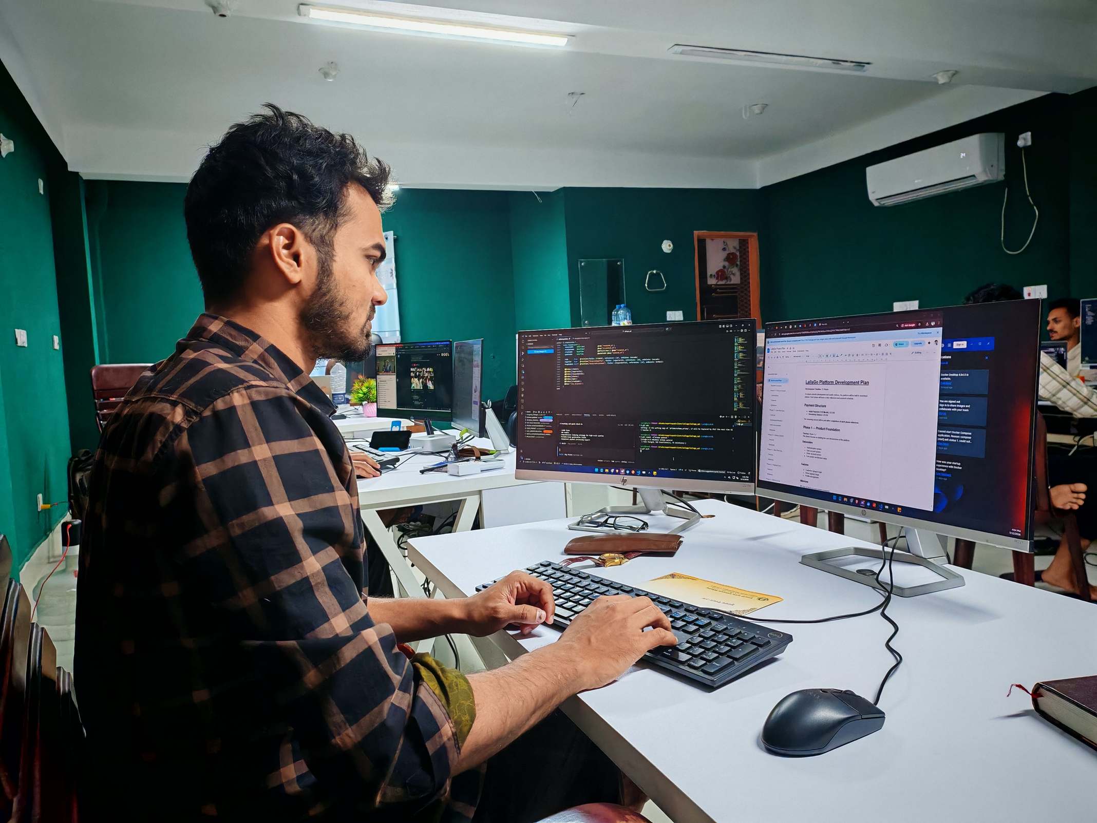 Software developer working at a computer in a workspace