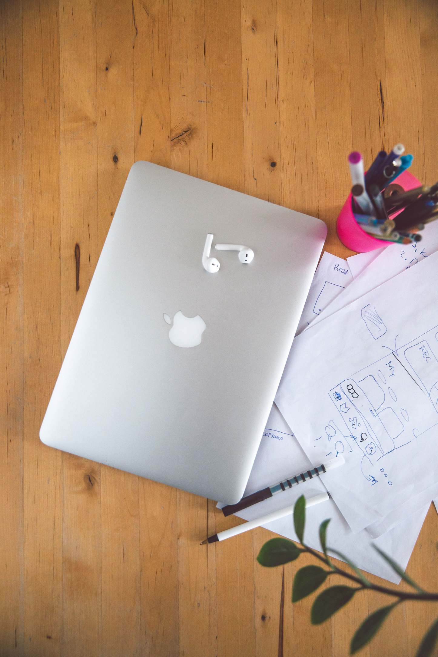Laptop open on a desk in a work area with office supplies